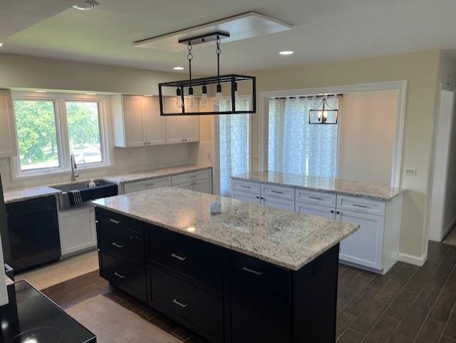 1901 NE River Ridge Rd, Saint Joseph, MO 64507 - kitchen featuring a kitchen island, dark cabinetry, white cabinets, dark wood-style flooring, and recessed lighting
