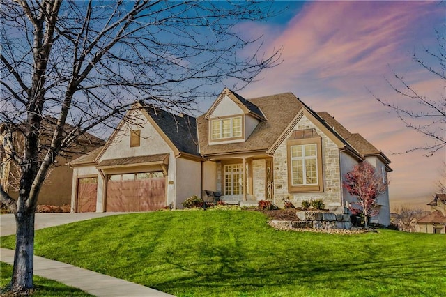 10654 W 168th Ct, Overland Park, KS 66221 - view of front of house featuring stone siding, a front lawn, stucco siding, and driveway