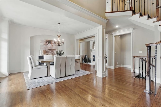 10654 W 168th Ct, Overland Park, KS 66221 - unfurnished dining area featuring ornamental molding, stairs, a chandelier, and wood finished floors