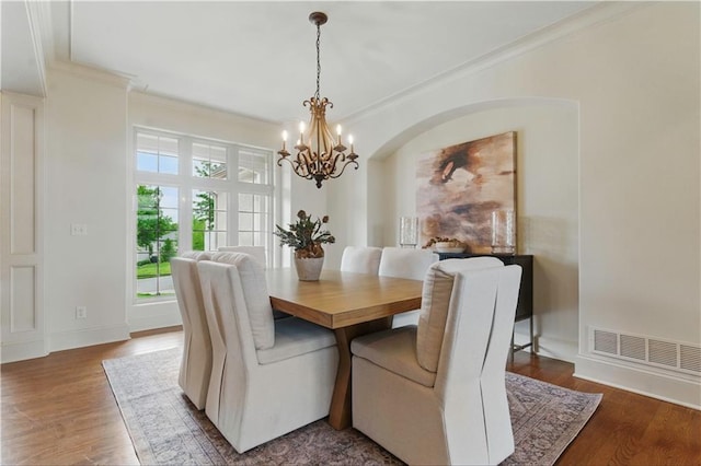 10654 W 168th Ct, Overland Park, KS 66221 - dining area with a chandelier, ornamental molding, and wood finished floors