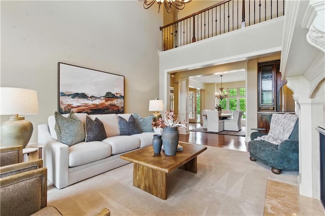 10654 W 168th Ct, Overland Park, KS 66221 - living room featuring a chandelier, a high ceiling, and a fireplace with flush hearth