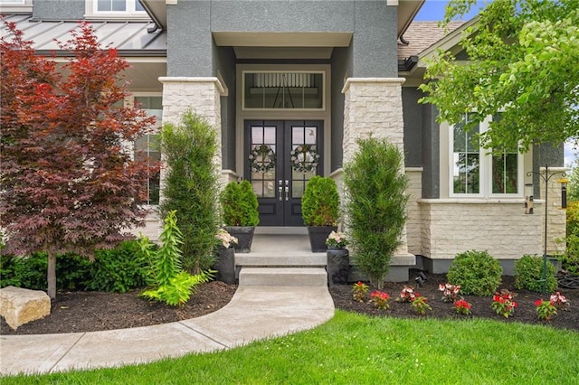 17117 Bluejacket St, Overland Park, KS 66221 - property entrance featuring french doors, stone siding, stucco siding, and a standing seam roof
