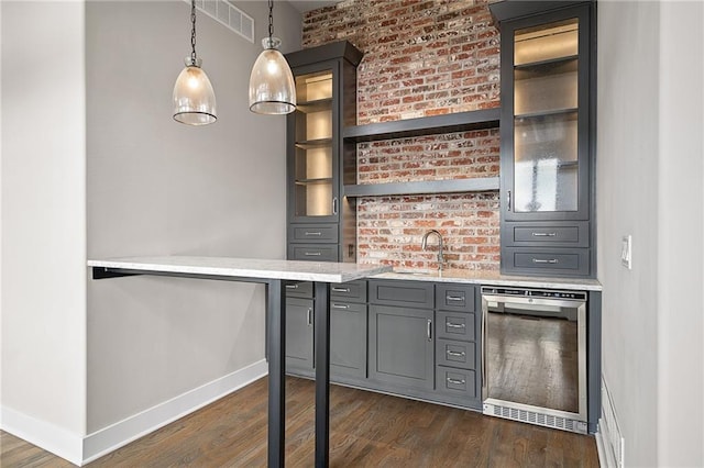 17117 Bluejacket St, Overland Park, KS 66221 - bar area featuring dark wood-type flooring, wine cooler, decorative light fixtures, and brick wall