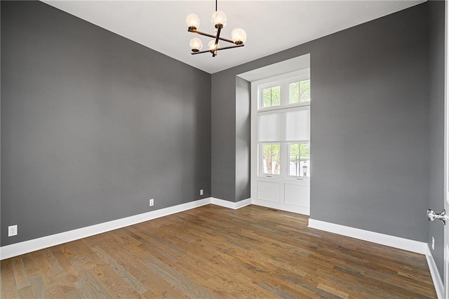 17117 Bluejacket St, Overland Park, KS 66221 - spare room featuring a chandelier and wood finished floors