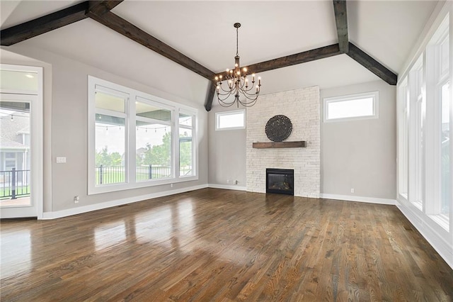 17117 Bluejacket St, Overland Park, KS 66221 - unfurnished living room featuring a chandelier, plenty of natural light, dark wood-style floors, and a fireplace