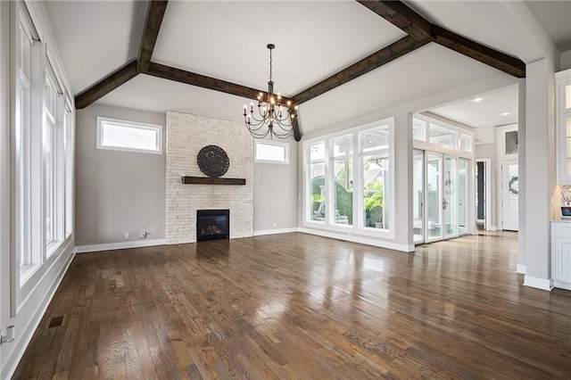 17117 Bluejacket St, Overland Park, KS 66221 - unfurnished living room featuring a chandelier, beamed ceiling, dark wood finished floors, and a large fireplace