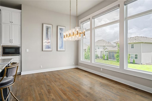 17117 Bluejacket St, Overland Park, KS 66221 - unfurnished dining area with a chandelier and dark wood-style flooring