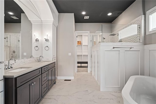17117 Bluejacket St, Overland Park, KS 66221 - full bath featuring a tile shower, double vanity, a freestanding tub, and marble look tile flooring