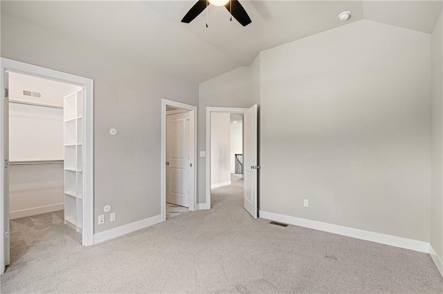 17117 Bluejacket St, Overland Park, KS 66221 - unfurnished bedroom featuring vaulted ceiling, a walk in closet, carpet floors, ceiling fan, and a closet