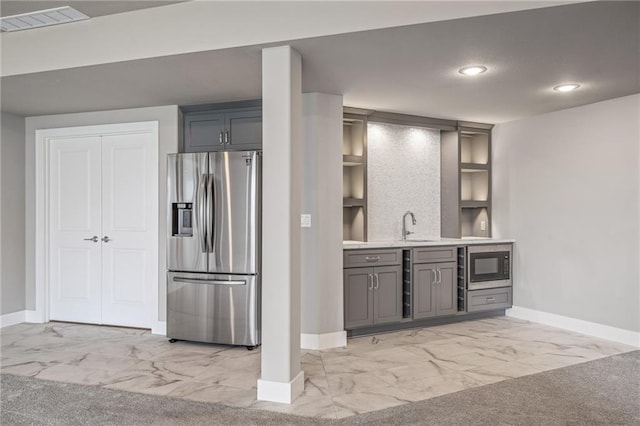 17117 Bluejacket St, Overland Park, KS 66221 - kitchen with stainless steel refrigerator with ice dispenser, light marble finish flooring, gray cabinetry, recessed lighting, and built in microwave