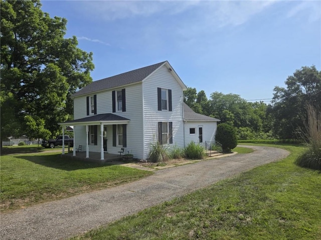 18916 166th St, Basehor, KS 66007 - view of property exterior featuring a yard, asphalt driveway, a shingled roof, and a porch
