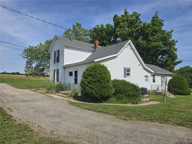 18916 166th St, Basehor, KS 66007 - view of side of home with a chimney and a shingled roof