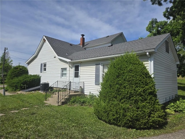 18916 166th St, Basehor, KS 66007 - rear view of property with a shingled roof, a yard, and a chimney