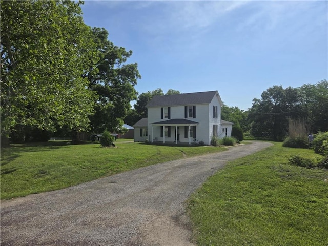 18916 166th St, Basehor, KS 66007 - view of front of home featuring driveway, a front lawn, and a porch