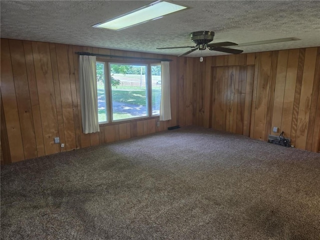 18916 166th St, Basehor, KS 66007 - carpeted spare room with a textured ceiling, a ceiling fan, and wooden walls