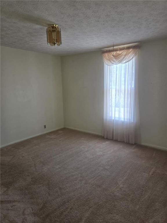 18916 166th St, Basehor, KS 66007 - carpeted spare room featuring a textured ceiling and baseboards