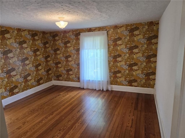 18916 166th St, Basehor, KS 66007 - spare room featuring a textured ceiling, wood finished floors, and wallpapered walls