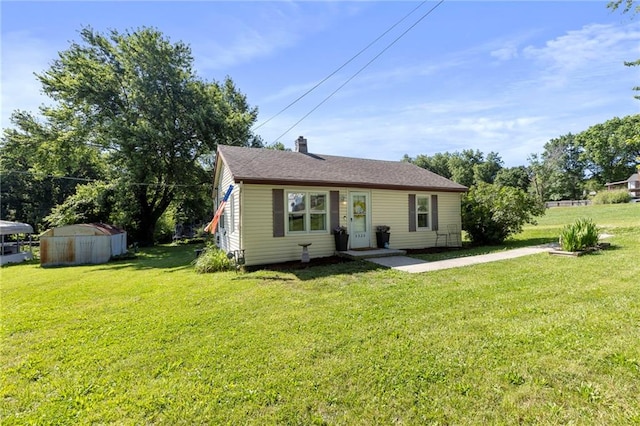 5525 NE Meadowbrook Rd, Kansas City, MO 64119 - view of front facade with a front lawn, a chimney, and an outbuilding