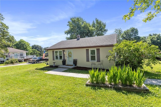 5525 NE Meadowbrook Rd, Kansas City, MO 64119 - view of front of house featuring a front lawn and a chimney