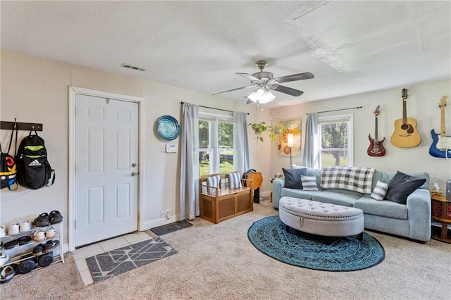 5525 NE Meadowbrook Rd, Kansas City, MO 64119 - carpeted living room featuring plenty of natural light, a ceiling fan, and a textured ceiling