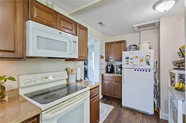 5525 NE Meadowbrook Rd, Kansas City, MO 64119 - kitchen featuring white appliances, dark wood-type flooring, light countertops, and a textured ceiling