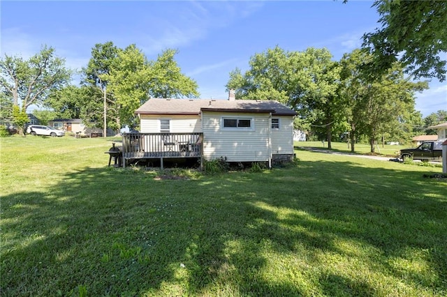 5525 NE Meadowbrook Rd, Kansas City, MO 64119 - rear view of house with a yard, a deck, and a chimney
