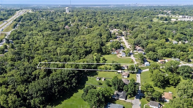 5525 NE Meadowbrook Rd, Kansas City, MO 64119 - aerial view of property and surrounding area featuring a forest and property parcel outlined