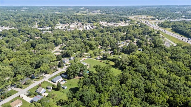 5525 NE Meadowbrook Rd, Kansas City, MO 64119 - aerial view of property and surrounding area featuring a heavily wooded area