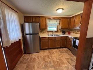 114 S Appleton St, Sugar Creek, MO 64054 - kitchen with freestanding refrigerator, range, brown cabinetry, and light countertops