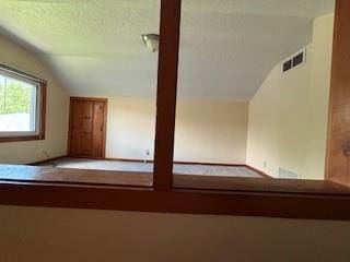 114 S Appleton St, Sugar Creek, MO 64054 - staircase with vaulted ceiling and a textured ceiling