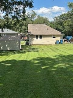 114 S Appleton St, Sugar Creek, MO 64054 - rear view of house with a lawn