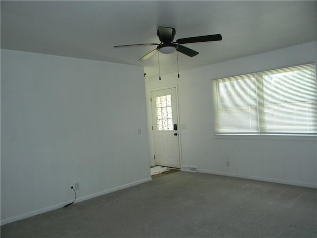 811 E Garfield St, Iola, KS 66749 - unfurnished room featuring ceiling fan and carpet flooring