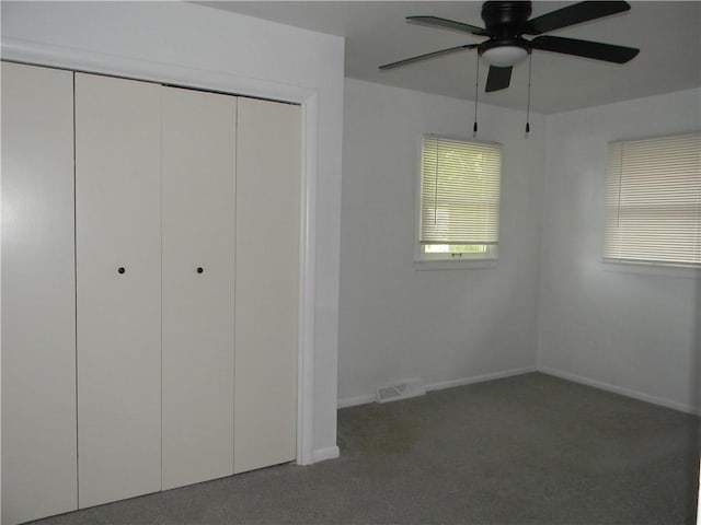 811 E Garfield St, Iola, KS 66749 - unfurnished bedroom with carpet, a closet, and a ceiling fan