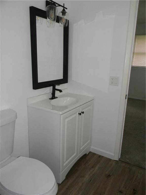 811 E Garfield St, Iola, KS 66749 - bathroom featuring vanity and wood finished floors