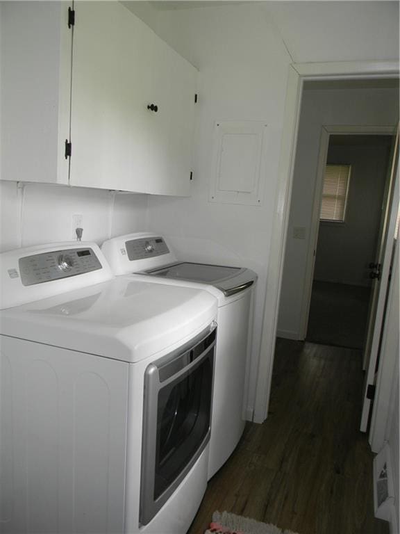 811 E Garfield St, Iola, KS 66749 - laundry room featuring washing machine and dryer, dark wood-style floors, and cabinet space