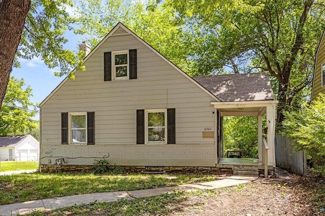 6701 Walrond Ave, Kansas City, MO 64132 - view of side of property featuring brick siding and a chimney
