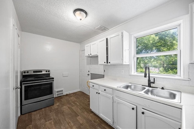 6701 Walrond Ave, Kansas City, MO 64132 - kitchen with stainless steel electric stove, white cabinets, dark wood-style floors, a textured ceiling, and light countertops
