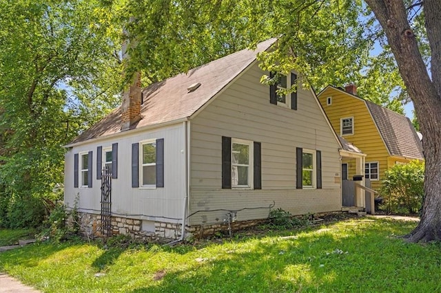 6701 Walrond Ave, Kansas City, MO 64132 - view of side of home with a chimney, a yard, and brick siding