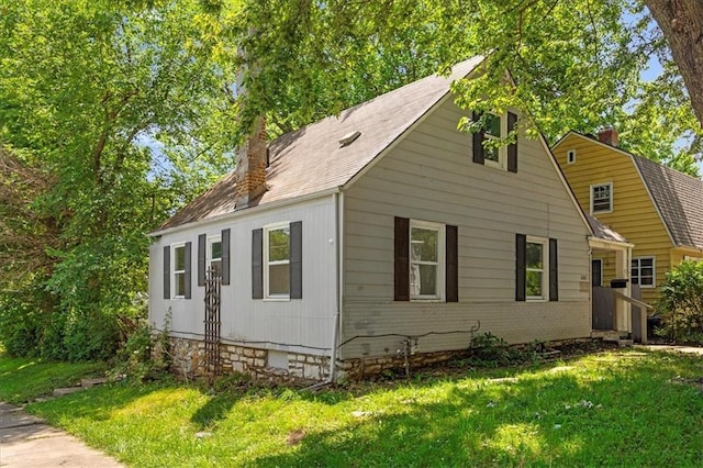 6701 Walrond Ave, Kansas City, MO 64132 - view of front of property with a chimney, a front yard, and brick siding