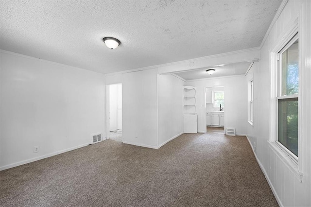 6701 Walrond Ave, Kansas City, MO 64132 - carpeted empty room featuring a textured ceiling and crown molding