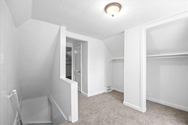 6701 Walrond Ave, Kansas City, MO 64132 - unfurnished bedroom with carpet floors, a textured ceiling, and lofted ceiling