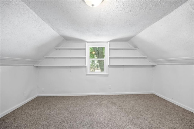 6701 Walrond Ave, Kansas City, MO 64132 - additional living space with a textured ceiling, carpet flooring, and vaulted ceiling