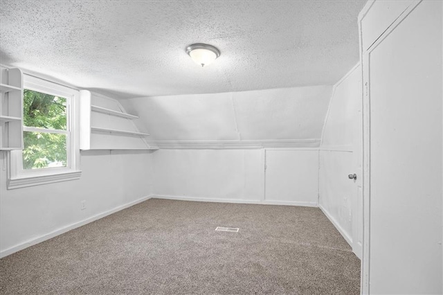 6701 Walrond Ave, Kansas City, MO 64132 - bonus room featuring vaulted ceiling, a textured ceiling, and carpet