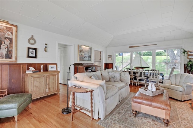 3 M St, Lake Lotawana, MO 64086 - living room with vaulted ceiling and light wood-style floors