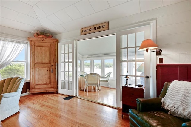 3 M St, Lake Lotawana, MO 64086 - living area with healthy amount of natural light, light wood-style floors, a water view, and vaulted ceiling