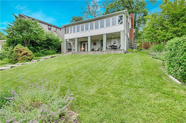 3 M St, Lake Lotawana, MO 64086 - rear view of house featuring a lawn, a patio area, a chimney, and stairway