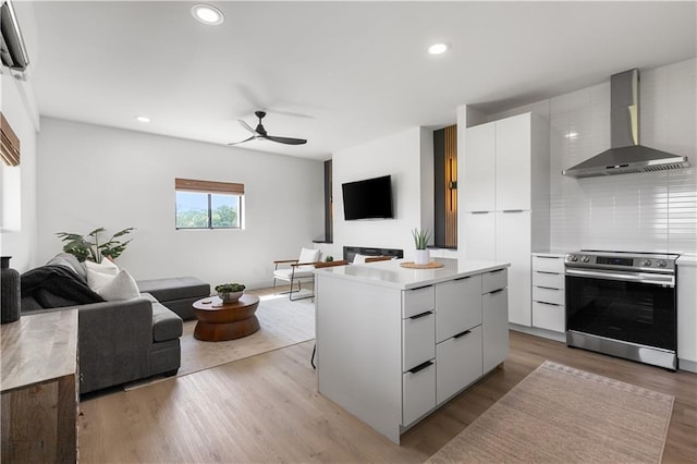 1372 N 150th Rd, Baldwin City, KS 66006 - kitchen with stainless steel electric range, modern cabinets, wall chimney range hood, open floor plan, and ceiling fan