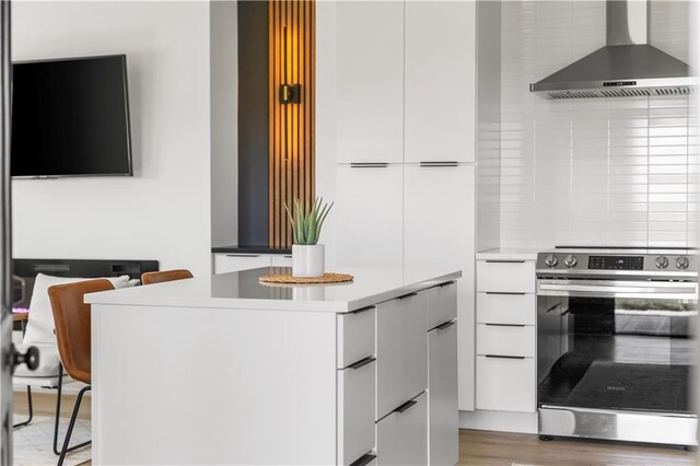 1372 N 150th Rd, Baldwin City, KS 66006 - kitchen featuring wall chimney exhaust hood, stainless steel range with electric cooktop, modern cabinets, white cabinetry, and light countertops