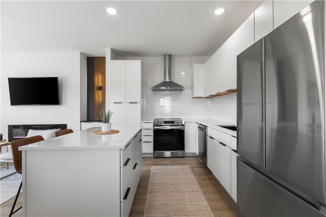 1372 N 150th Rd, Baldwin City, KS 66006 - kitchen featuring appliances with stainless steel finishes, wall chimney range hood, modern cabinets, a center island, and light countertops