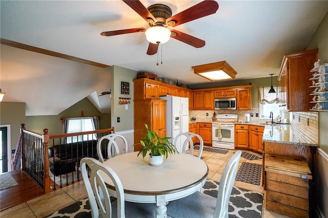 101 Shasta Daisy Dr, Smithville, MO 64089 - dining space with ceiling fan, light tile patterned floors, and crown molding